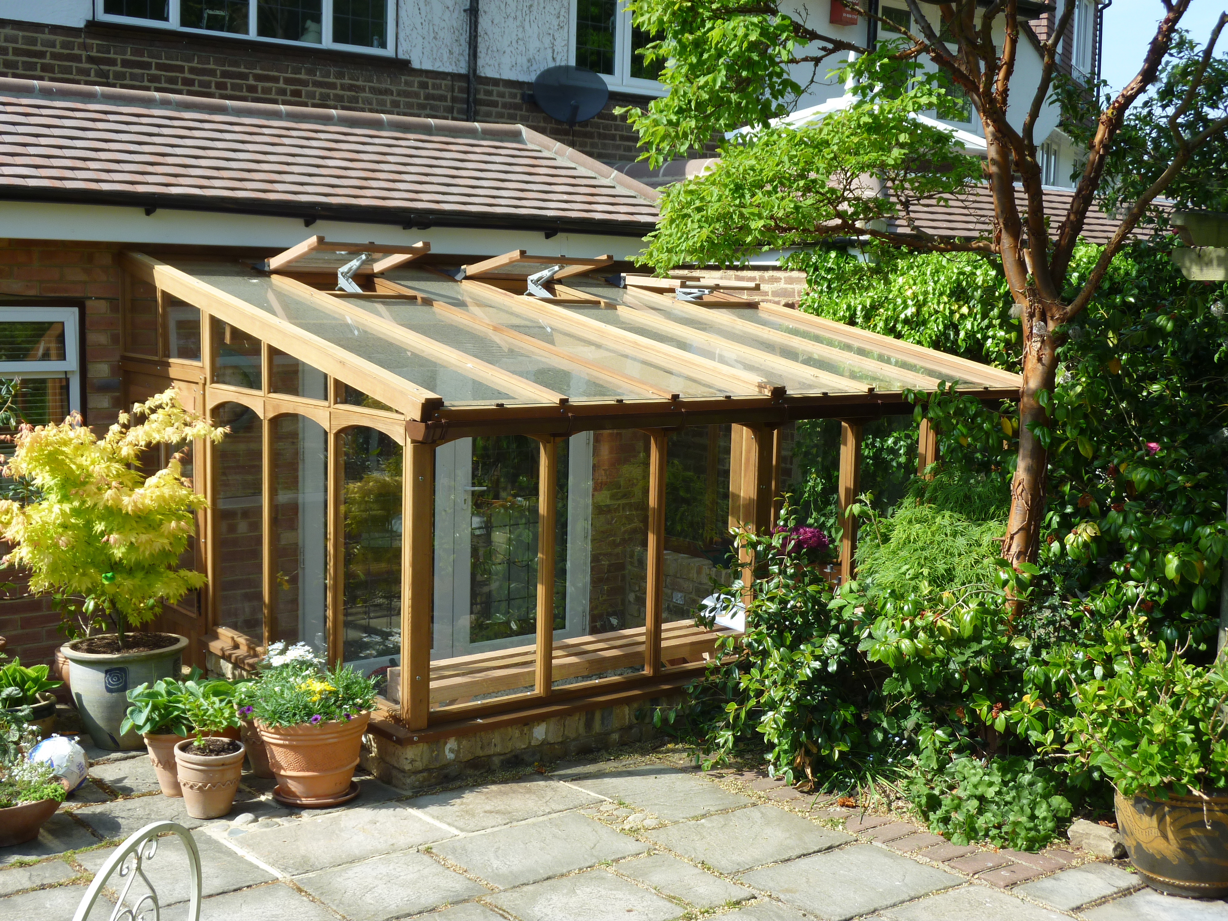 Cedar greenhouse with arched window
